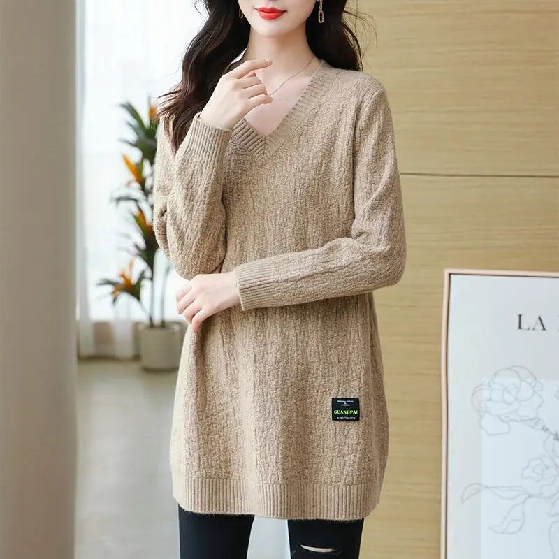 Women's knit sweater with V-neck, mid-length.